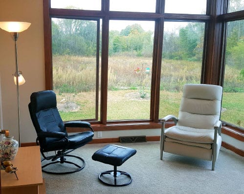 Numerous Amenities Slide 5 - 2 chairs with a view to outside